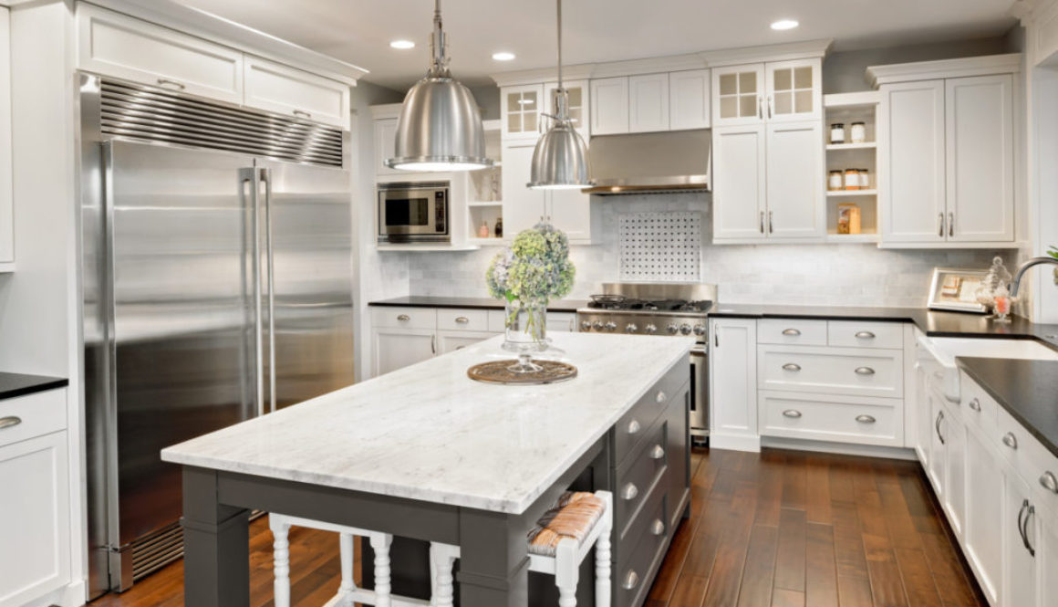 Beautiful Kitchen in Luxury Home with Island, Hardwood Floors, and Stainless Steel Refrigerator